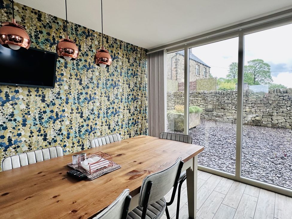 A dining room with a table and chairs at Pastures Barn in Bradnop near Leek