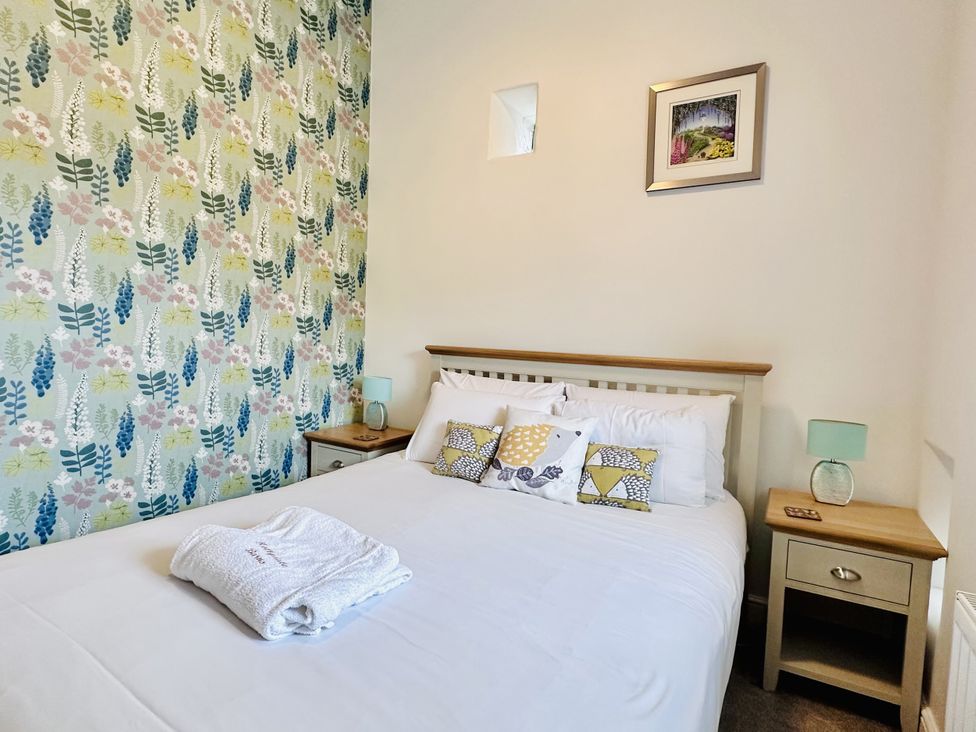 A bedroom with a bed and bedside table at Pastures Barn Bradnop near Leek