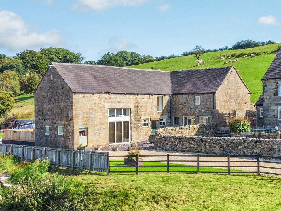 A stone house with windows and a fence at Pastures Barn Bradnop near Leek