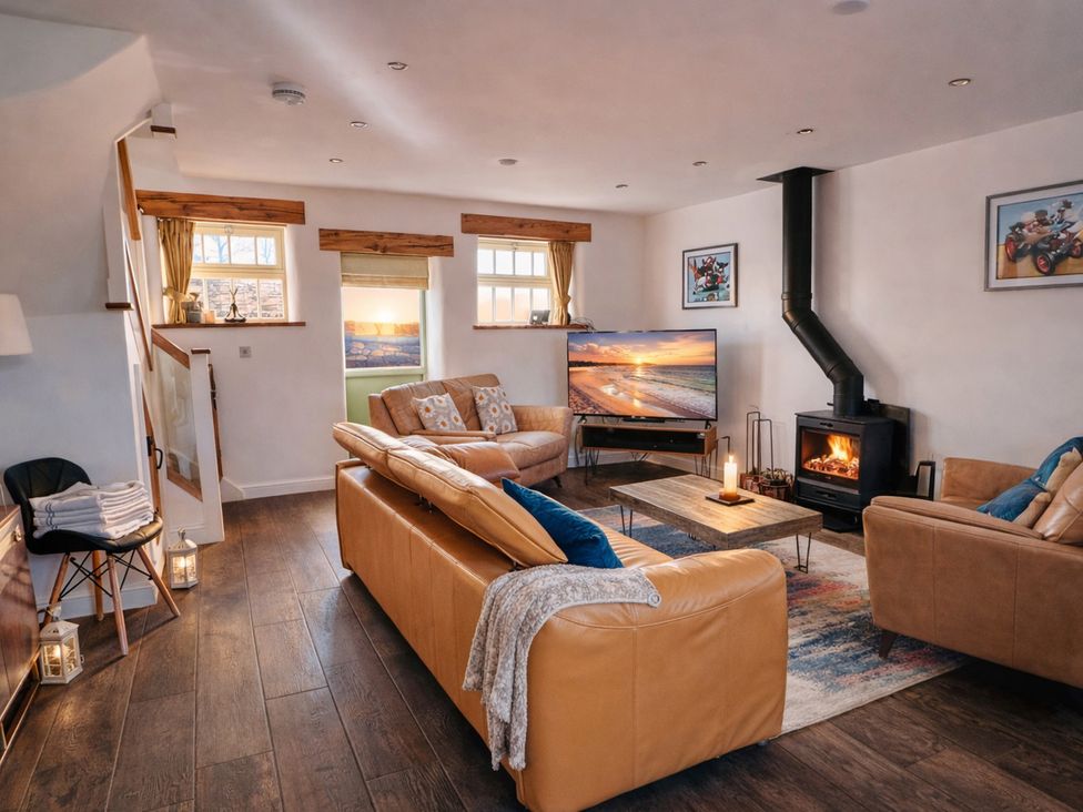 A living room with a sofa and television at Pastures Barn Bradnop near Leek