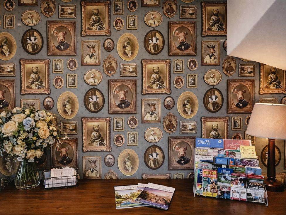 A reception area with a framed photograph wall at Pastures Barn Bradnop near Leek