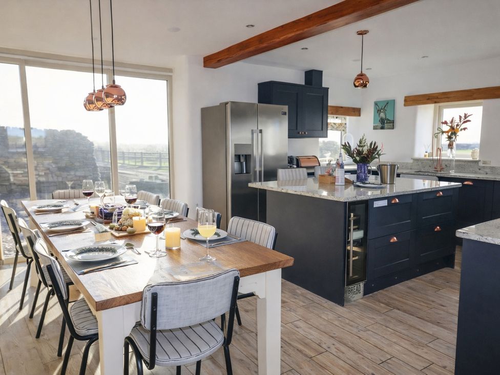 A kitchen with a dining table and chairs at Pastures Barn Bradnop near Leek