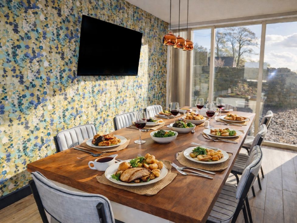A dining room with a table set for a meal at Pastures Barn near Leek