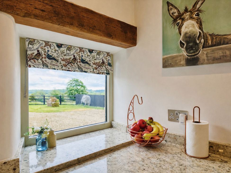 A kitchen countertop with a fruit bowl and window at Pastures Barn in Bradnop near Leek