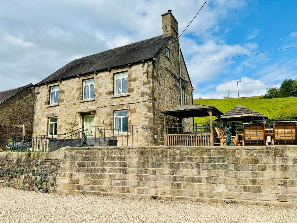 A stone house with a gazebo and lawn at HollyDale in Bradnop near Leek