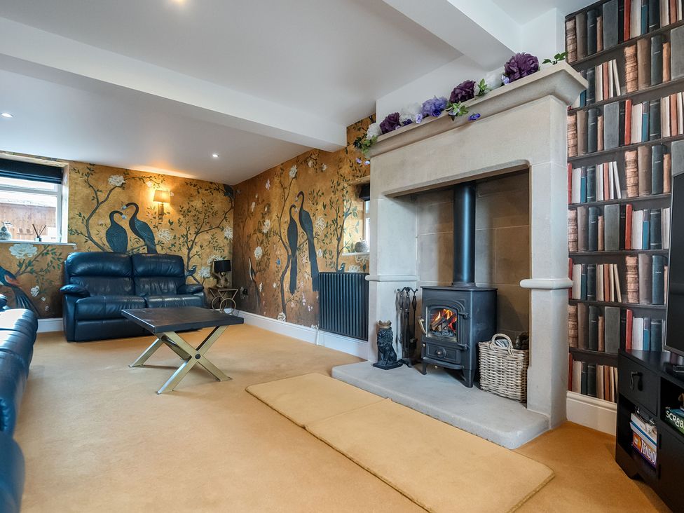 A living room with a fireplace and sofa at HollyDale in Bradnop near Leek