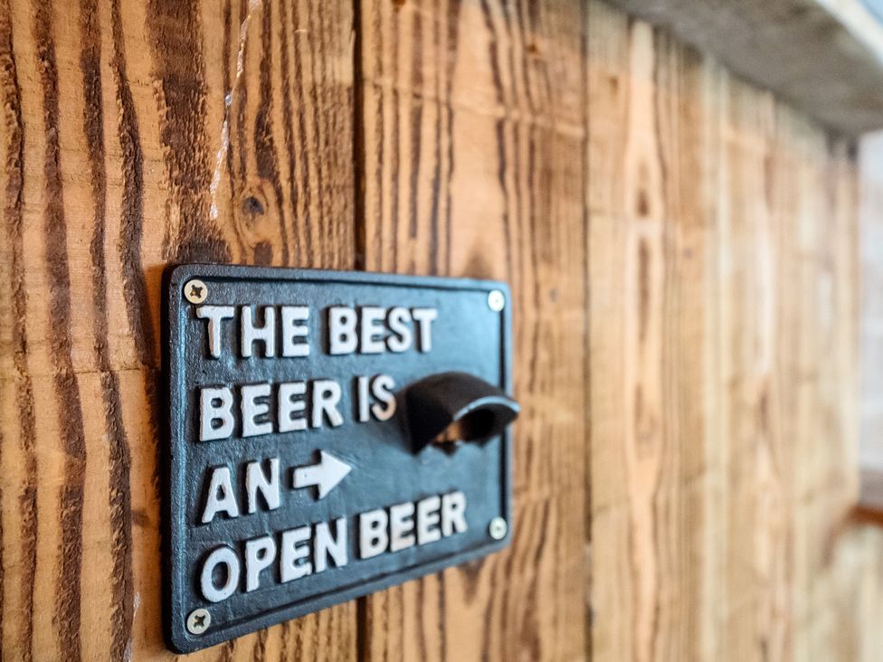 A sign on a wall with a bottle opener at HollyDale in Bradnop near Leek