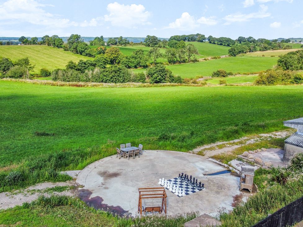 An outdoor area with a large chess set and table with chairs at HollyDale in Bradnop near Leek