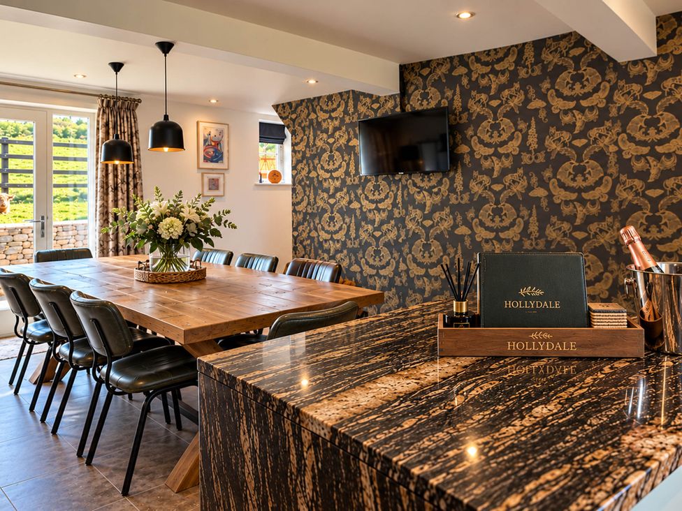 A dining room with a large table and chairs at HollyDale in Bradnop near Leek