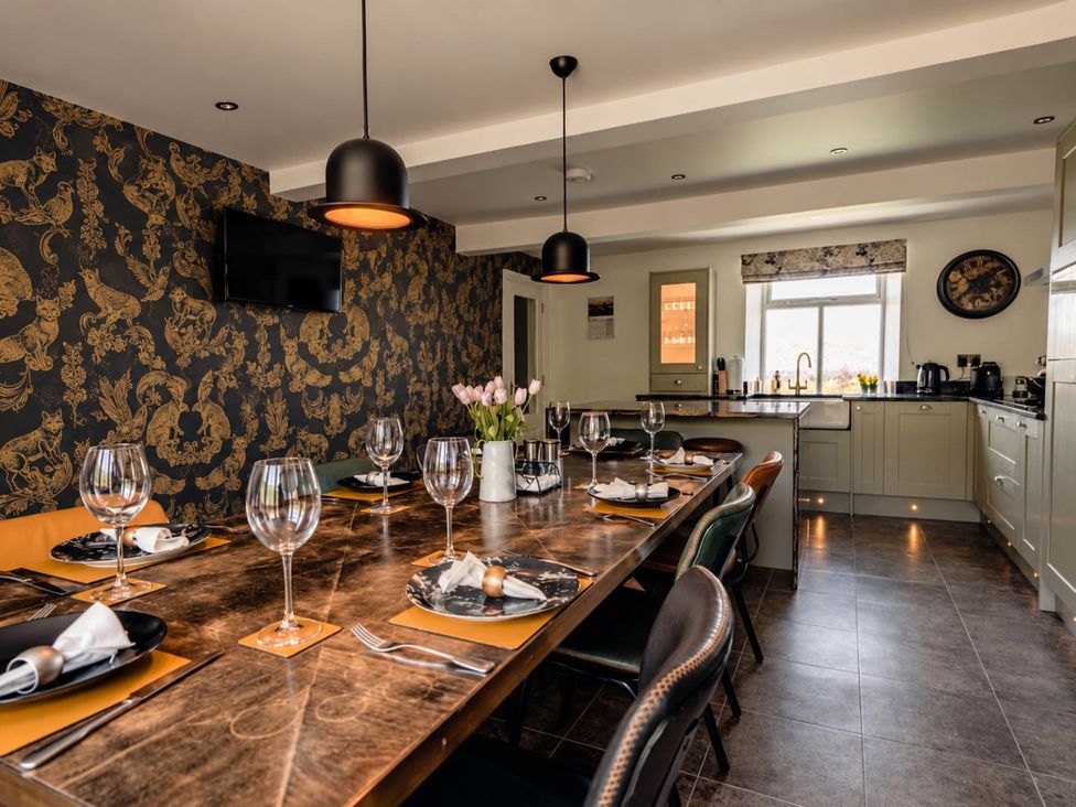 A dining room with a table set for dinner at HollyDale in Bradnop near Leek