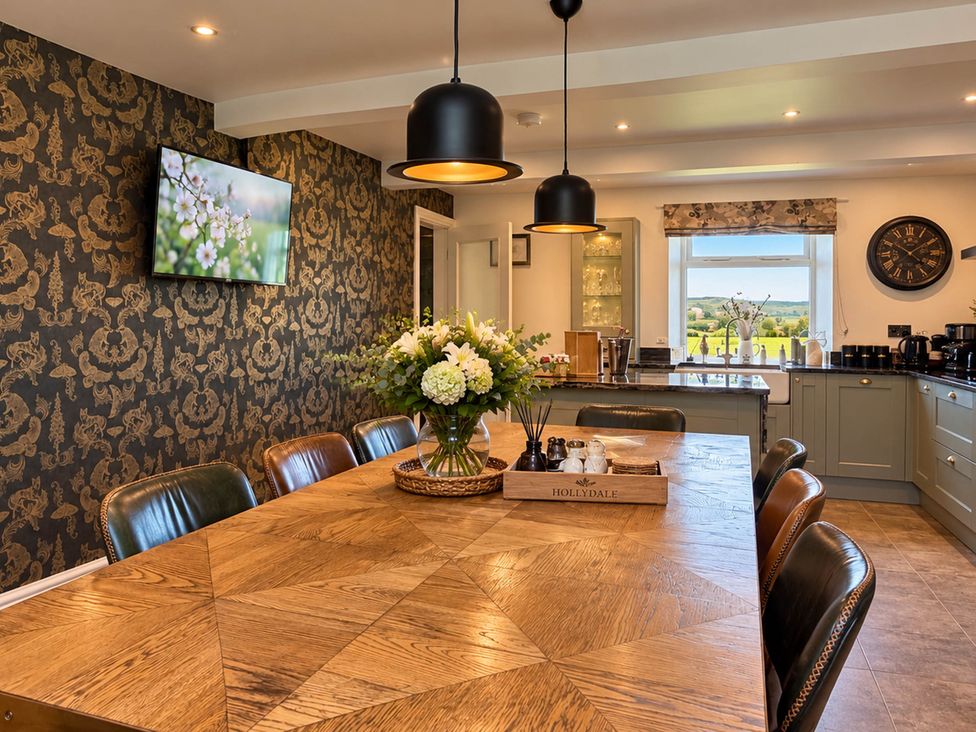 A dining room with a wooden table and chairs at HollyDale in Bradnop near Leek