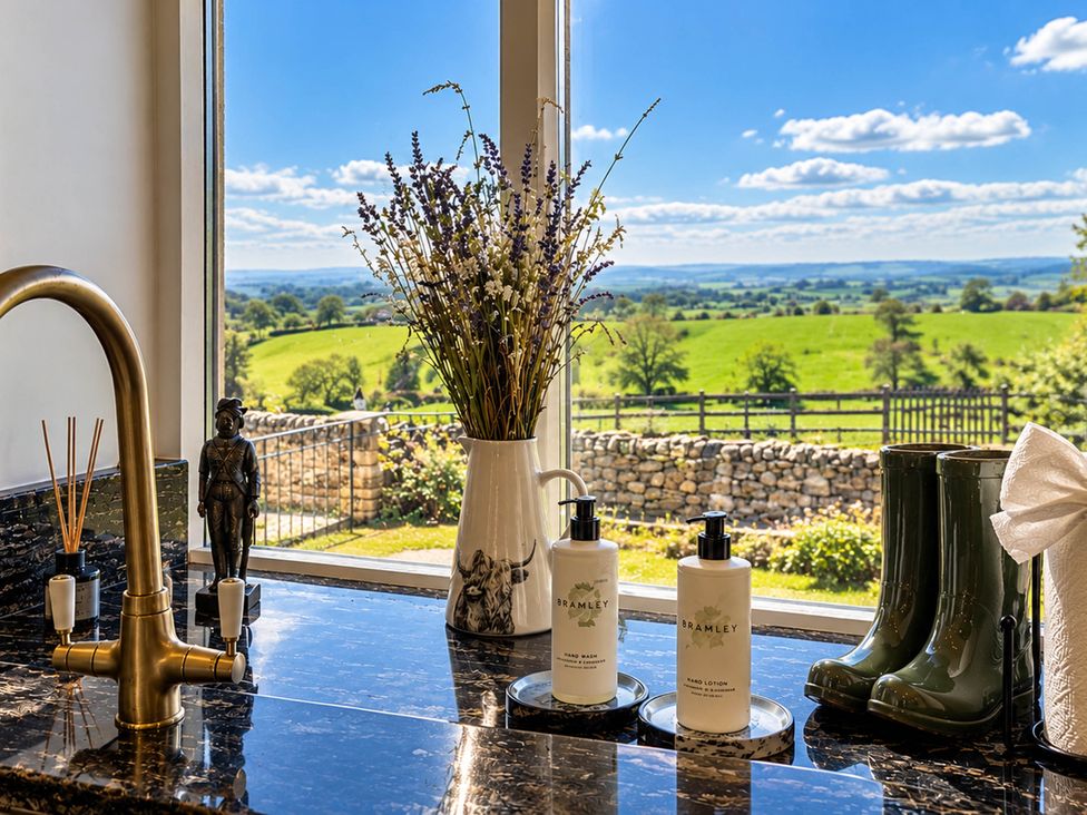 A bathroom countertop with soap dispensers and a view at HollyDale in Bradnop near Leek