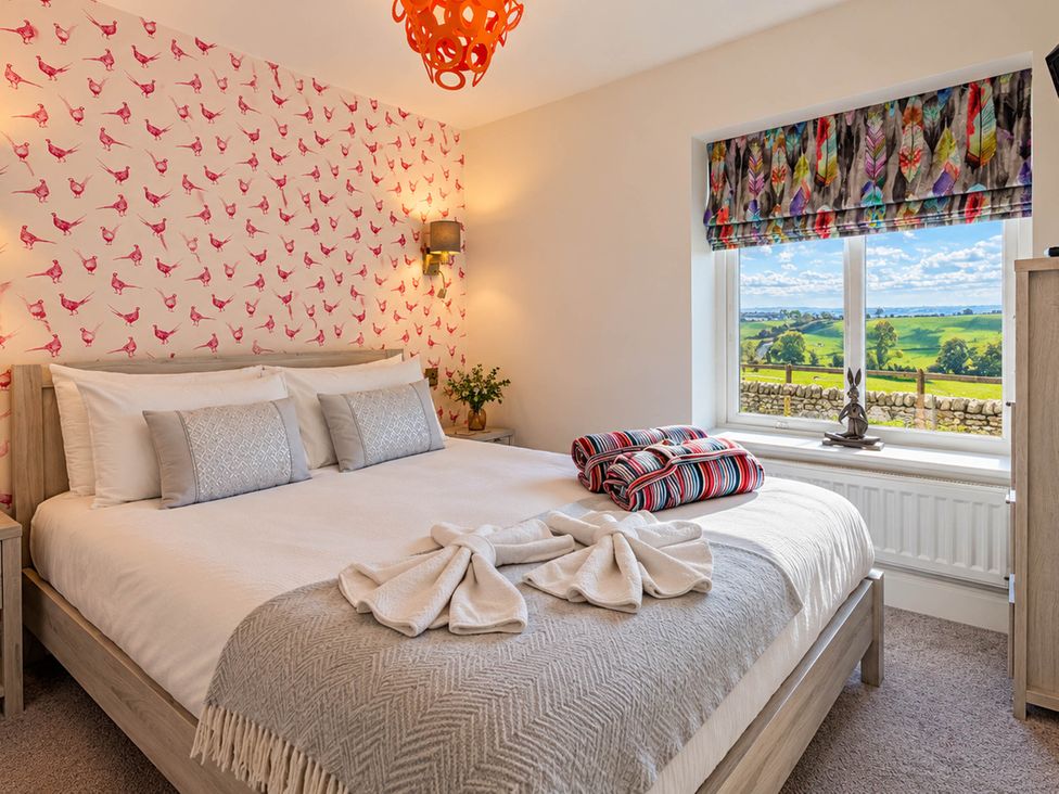 A bedroom with a bed and window view at HollyDale in Bradnop near Leek