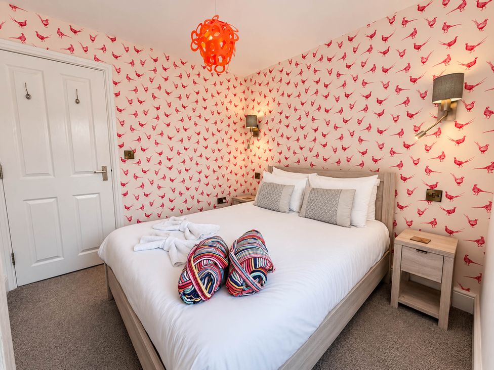 A bedroom with a bed and nightstand at HollyDale in Bradnop near Leek