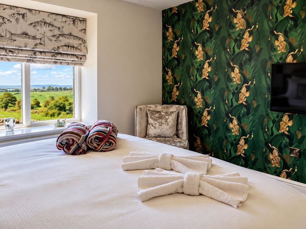 A bedroom with window, bed, and television at HollyDale in Bradnop near Leek