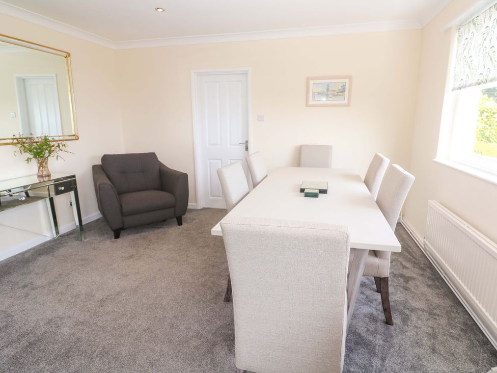 A dining room with a table and chairs at Karenza in Penzance