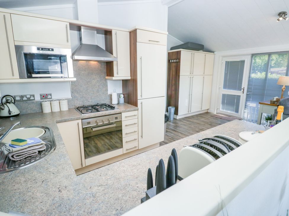 A kitchen with modern appliances at Dovedale Lodge Troutbeck Bridge