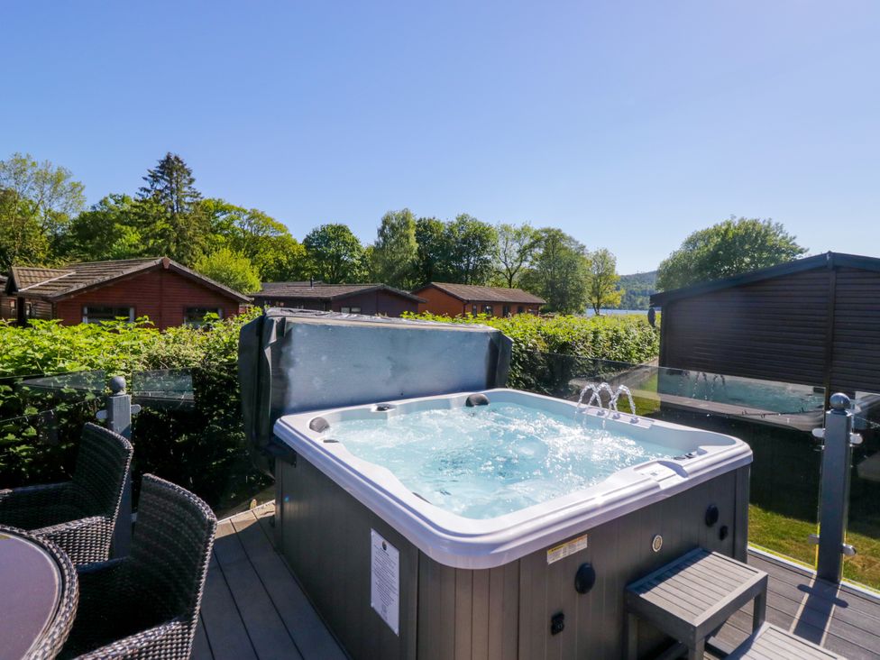 An outdoor area featuring a hot tub near lodges at Dovedale Lodge in Troutbeck Bridge