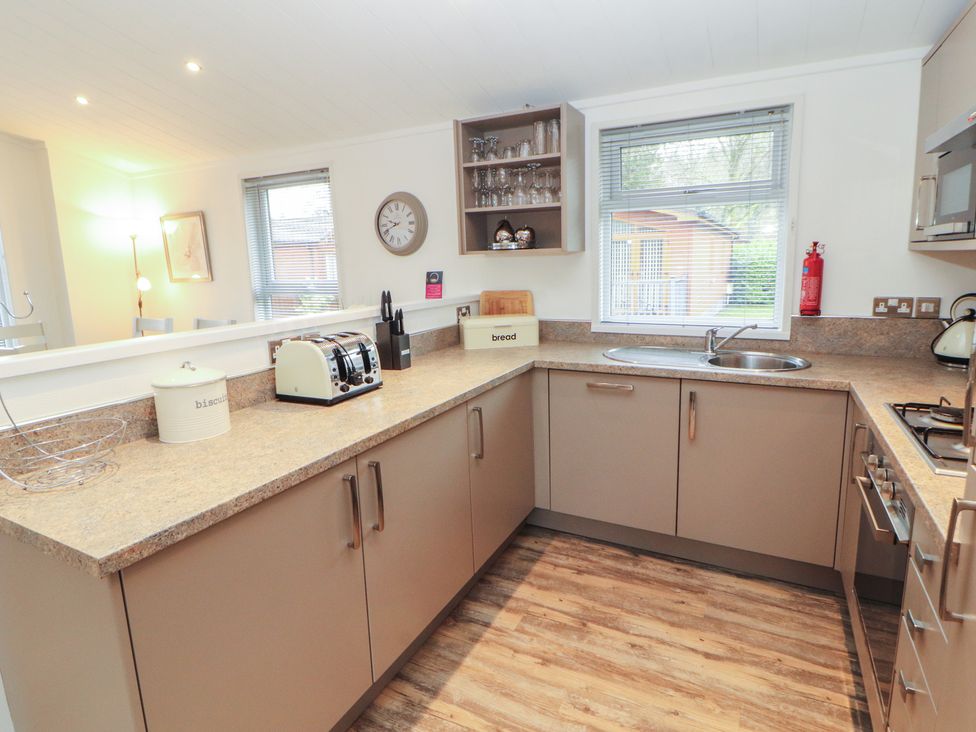 A kitchen with appliances including a toaster and kettle at Dovedale Lodge Bowness 70, White Cross Bay near Windermere