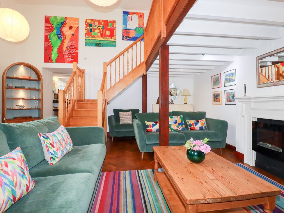 A living room with a sofa and coffee table at Rosemaddon in Crantock