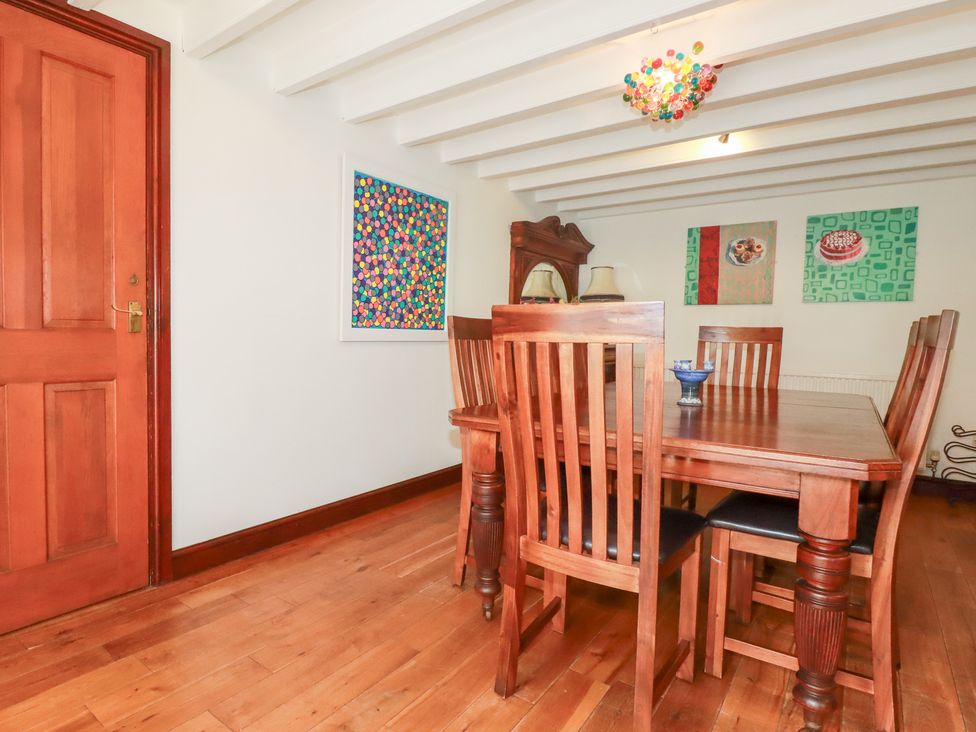 A dining room with a table and chairs at Rosemaddon in Crantock