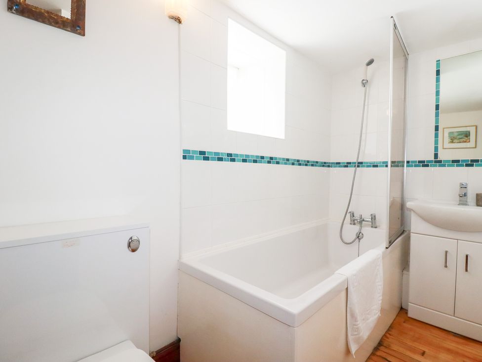 A bathroom with a sink, shower, bathtub and toilet at Rosemaddon in Crantock