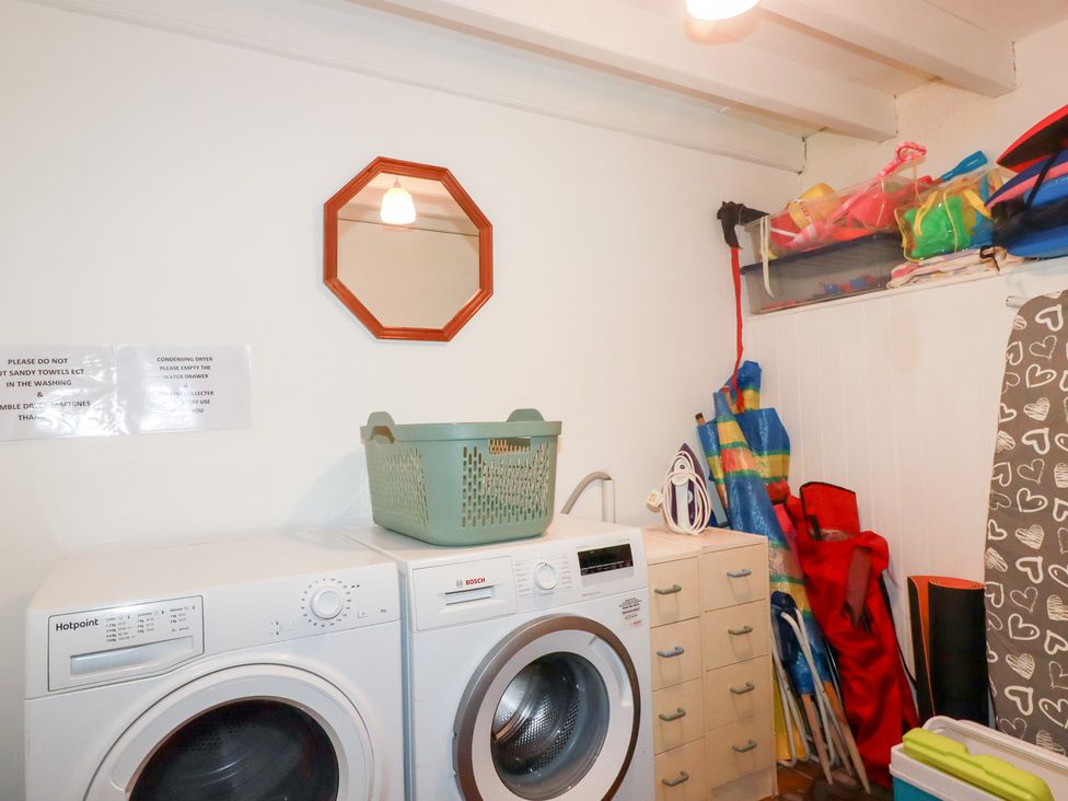 A laundry room with a washing machine and dryer at Rosemaddon in Crantock