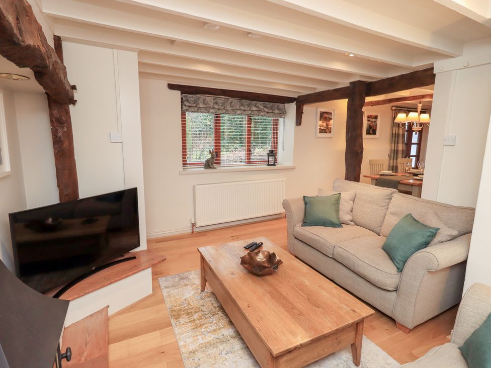 A living room with a sofa and coffee table at Jasmine Cottage Thornthwaite