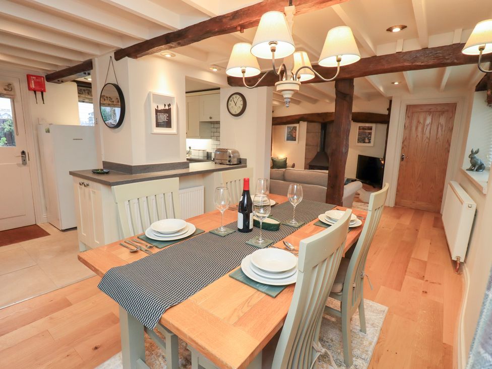 A dining room with a table set for dinner at Jasmine Cottage in Thornthwaite