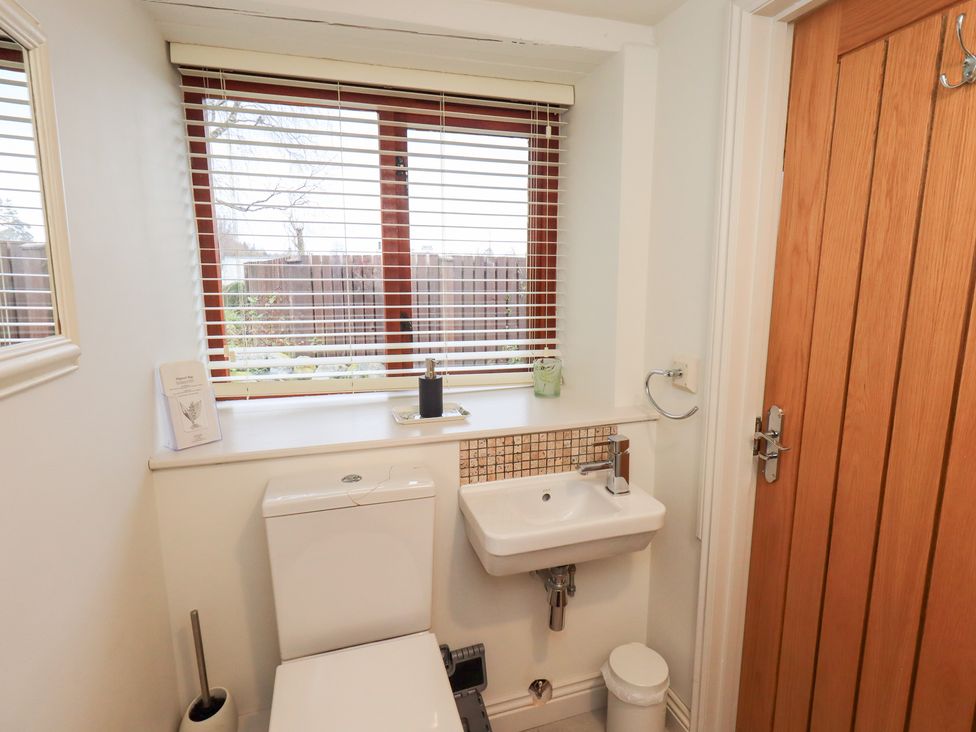 A bathroom with a toilet and sink at Jasmine Cottage in Thornthwaite