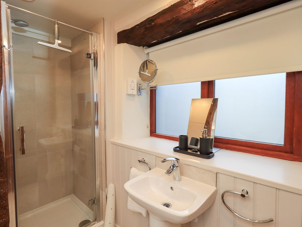 A bathroom with a shower and sink at Jasmine Cottage in Thornthwaite
