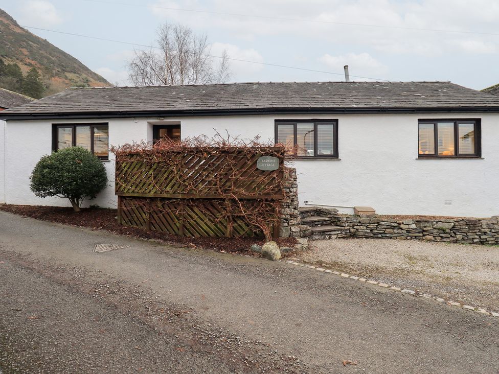 A cottage with windows and a path at Jasmine Cottage in Thornthwaite