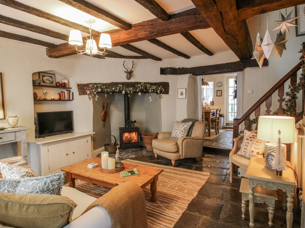 A living room with a fireplace and seating area at 8 Welsh Street in Bishops Castle
