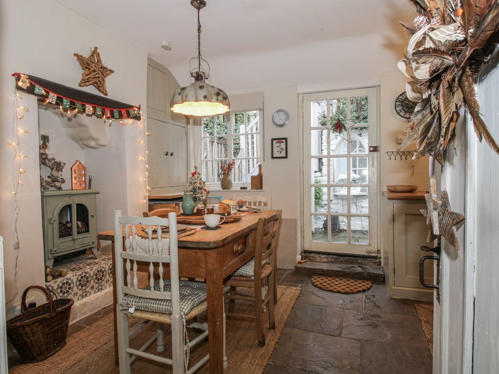 A kitchen with a dining table and chairs at 8 Welsh Street in Bishops Castle