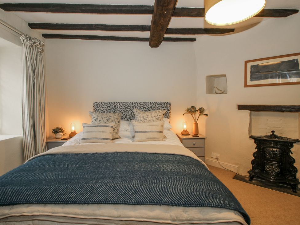 A bedroom with a bed and bedside tables at 8 Welsh Street Bishops Castle