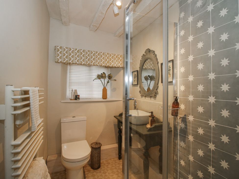 A bathroom with shower and sink at 8 Welsh Street Bishops Castle