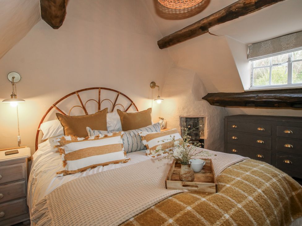 A bedroom with a bed and chest of drawers at 8 Welsh Street Bishops Castle