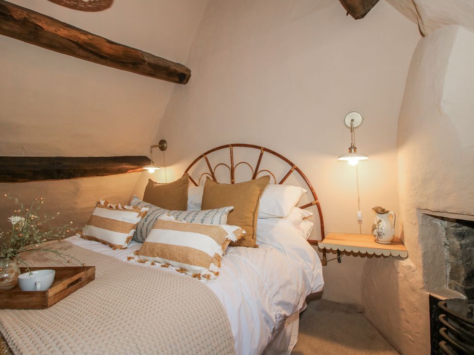A bedroom with a bed and bedside table at 8 Welsh Street in Bishops Castle