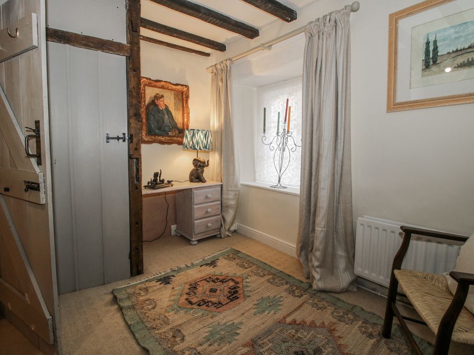 A bedroom with a painting and lamp at 8 Welsh Street, Bishop's Castle