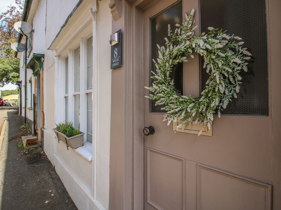 A door with a wreath and window at 8 Welsh Street in Bishop's Castle