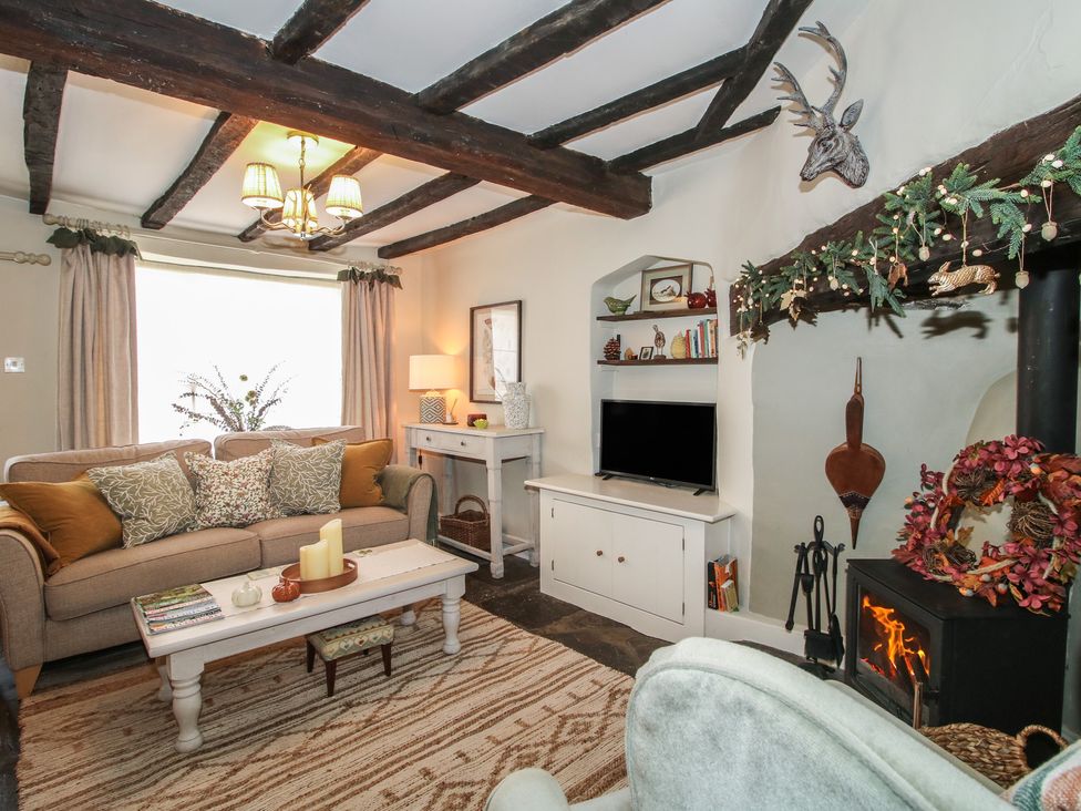 A living room with a sofa and a fireplace at 8 Welsh Street in Bishop's Castle