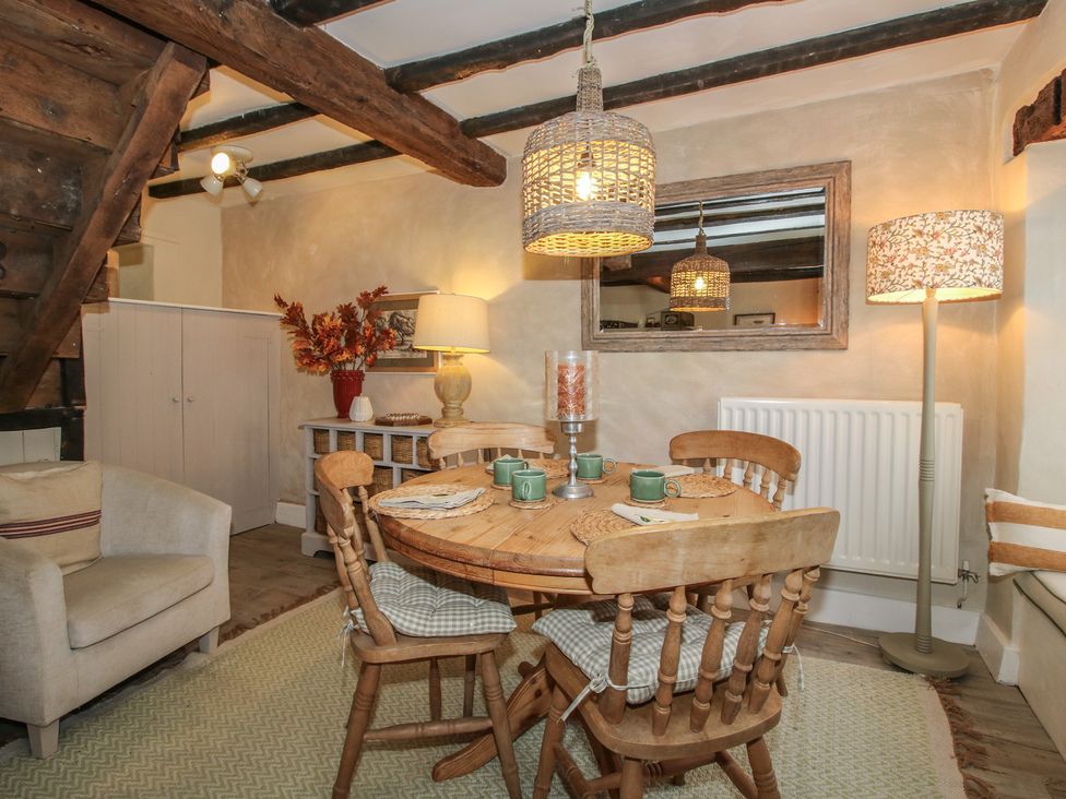 A dining room with a wooden table and chairs at 8 Welsh Street in Bishop's Castle
