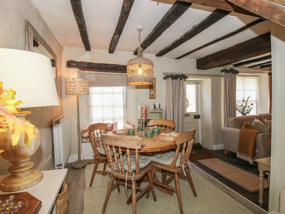 A dining room with a table and chairs at 8 Welsh Street in Bishop's Castle
