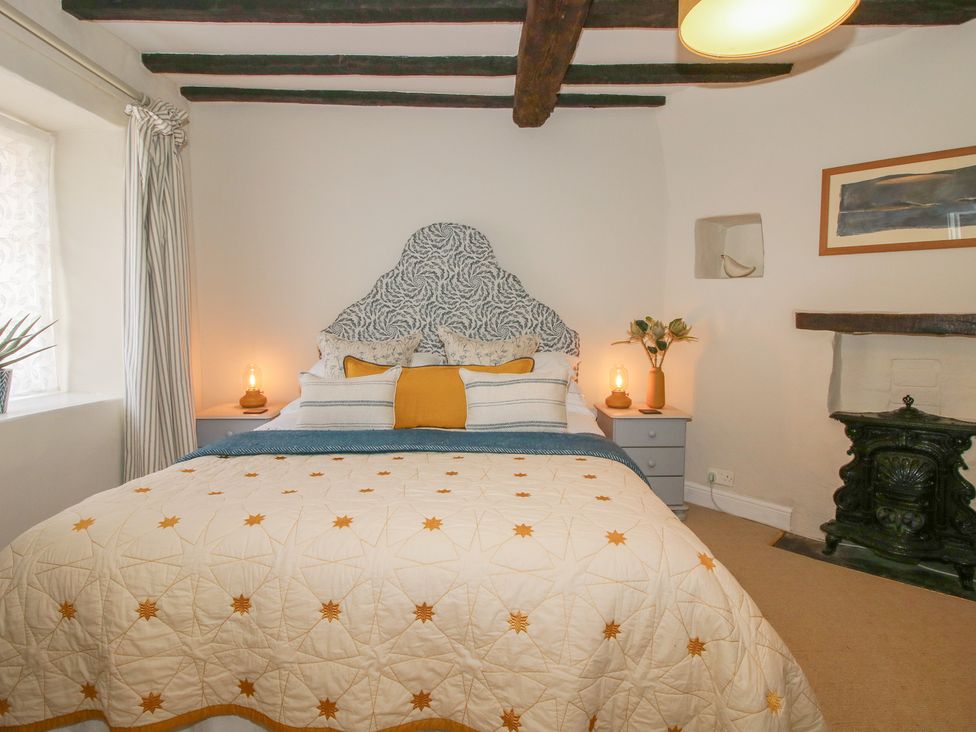 A bedroom with a bed and a fireplace at 8 Welsh Street in Bishop's Castle