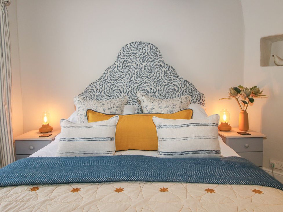 A bed with pillows and lamps at 8 Welsh Street Bishop's Castle