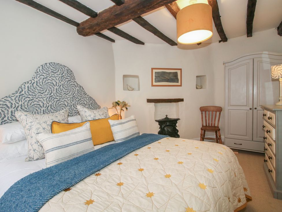 A bedroom with a bed and wardrobe at 8 Welsh Street in Bishop's Castle