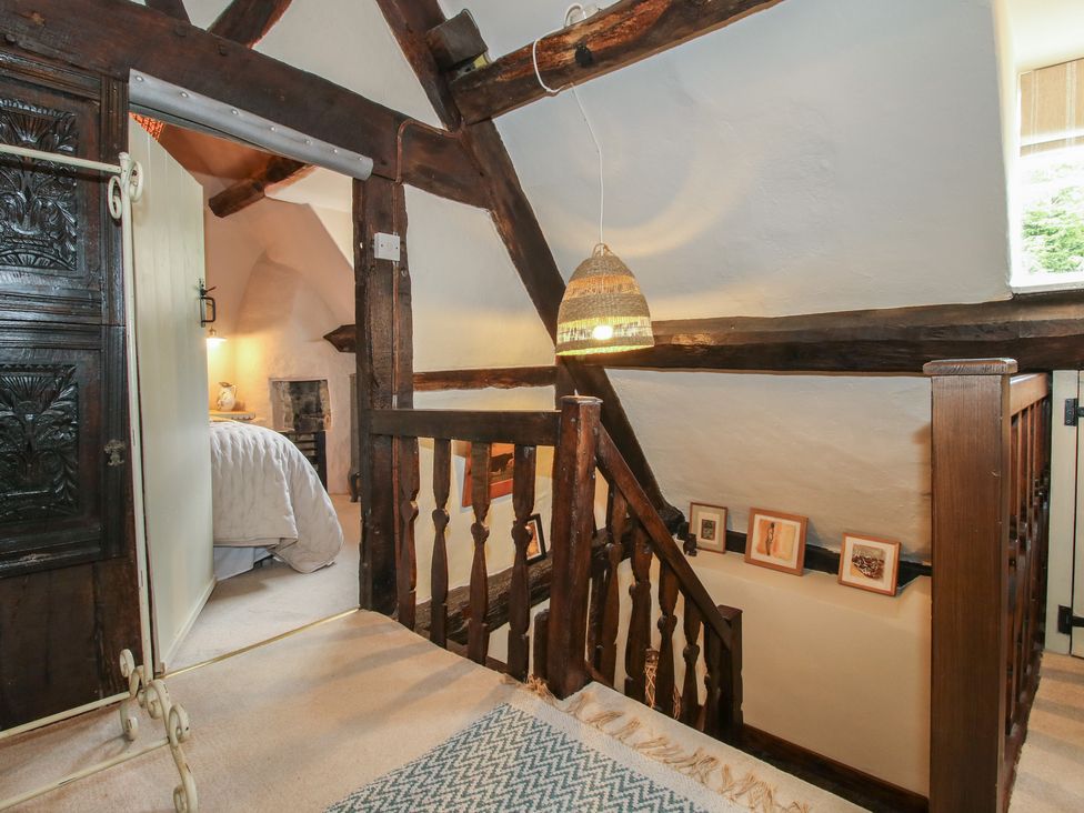 A hallway with a staircase and door at 8 Welsh Street in Bishop's Castle