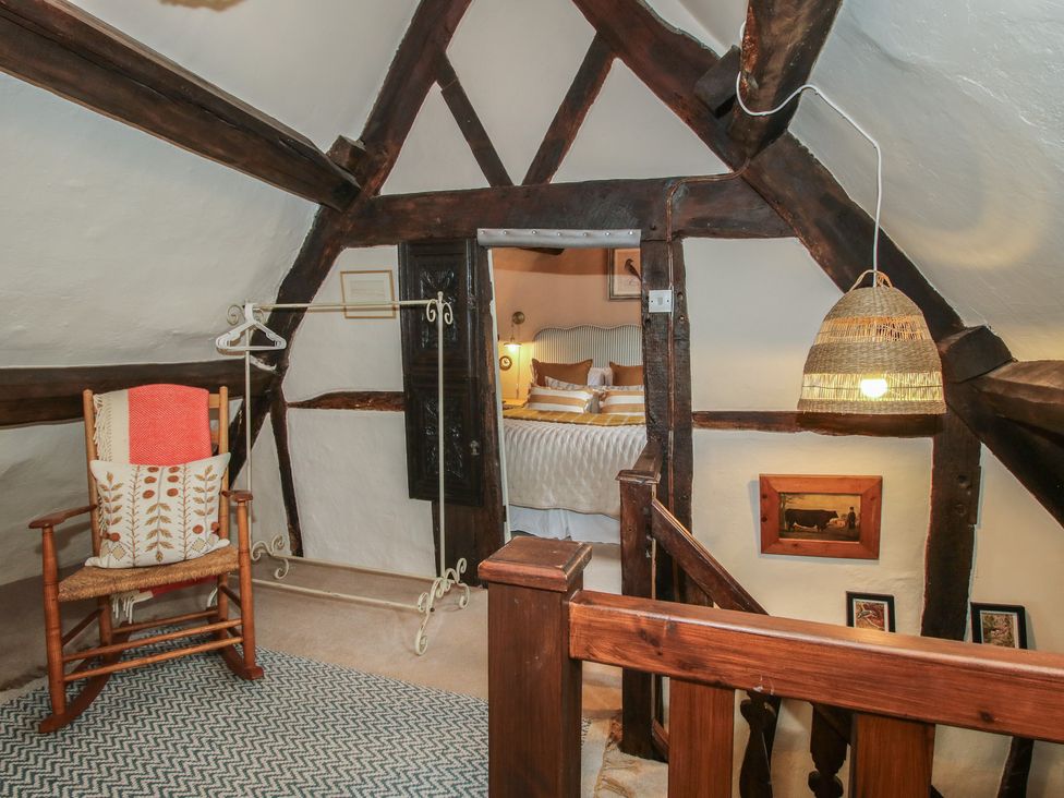 A bedroom with a rocking chair and a bed at 8 Welsh Street in Bishop's Castle