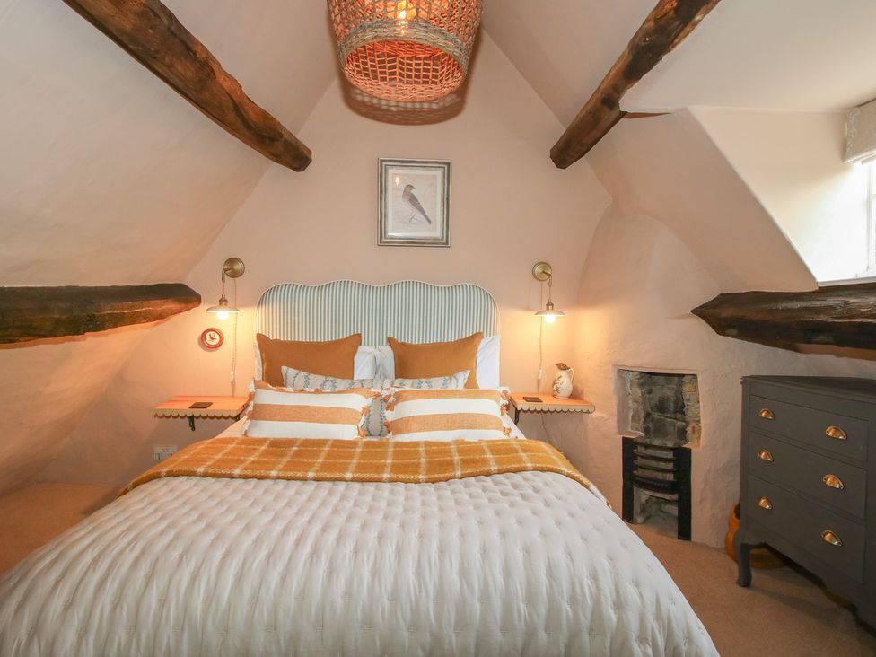 A bedroom with a bed and bedside table at 8 Welsh Street in Bishop's Castle