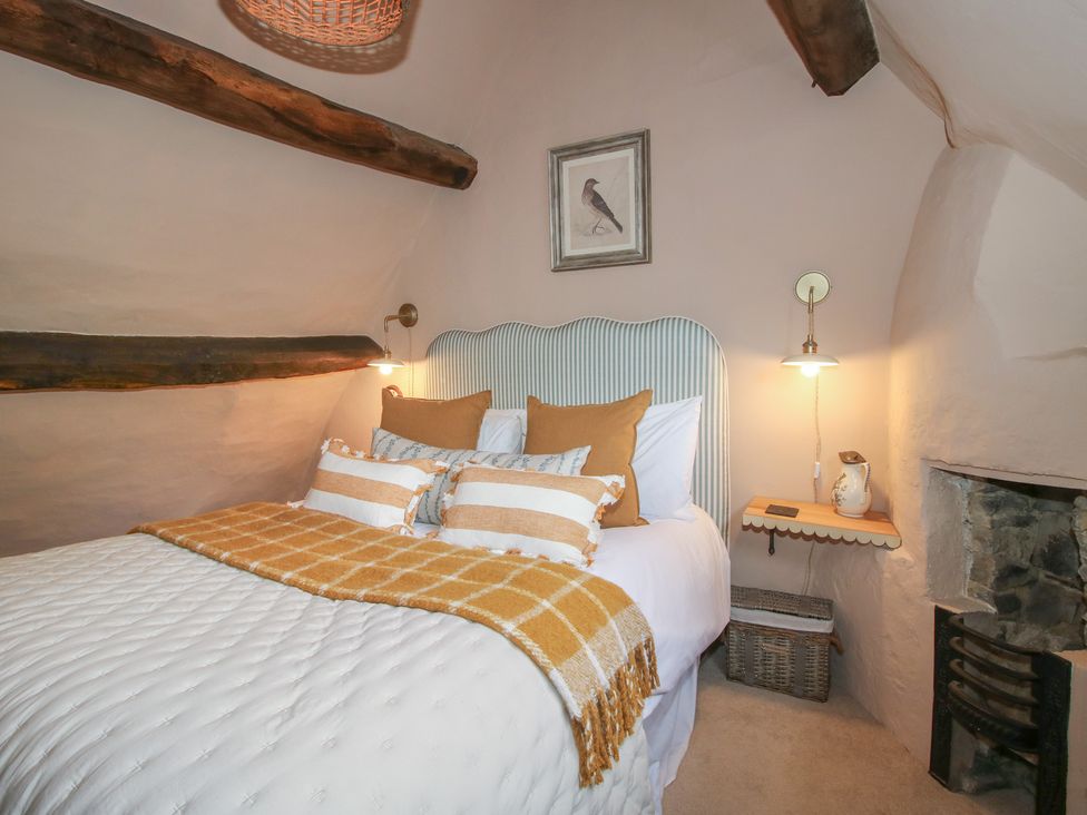 A bedroom with a bed and side table at 8 Welsh Street in Bishop's Castle